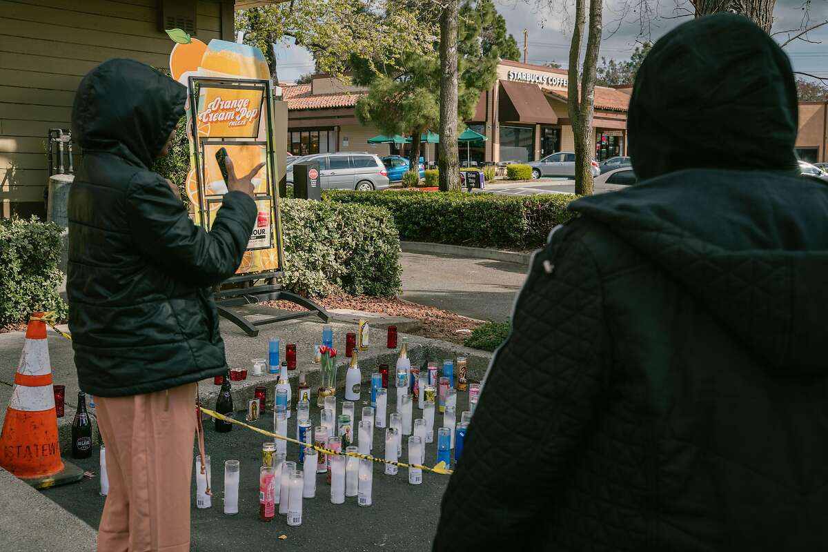 Family members who requested to remain anonymous, stand in front of a memorial for Willie McCoy of Vallejo, who was killed in an officer involved shooting in front of Taco Bell in Vallejo, Calif., on Monday, Feb. 11, 2019. One woman said, "He was my cousin. He was really young and he had a lot going on for himself. He didn’t deserve to die, they [police] should have gave him a chance."