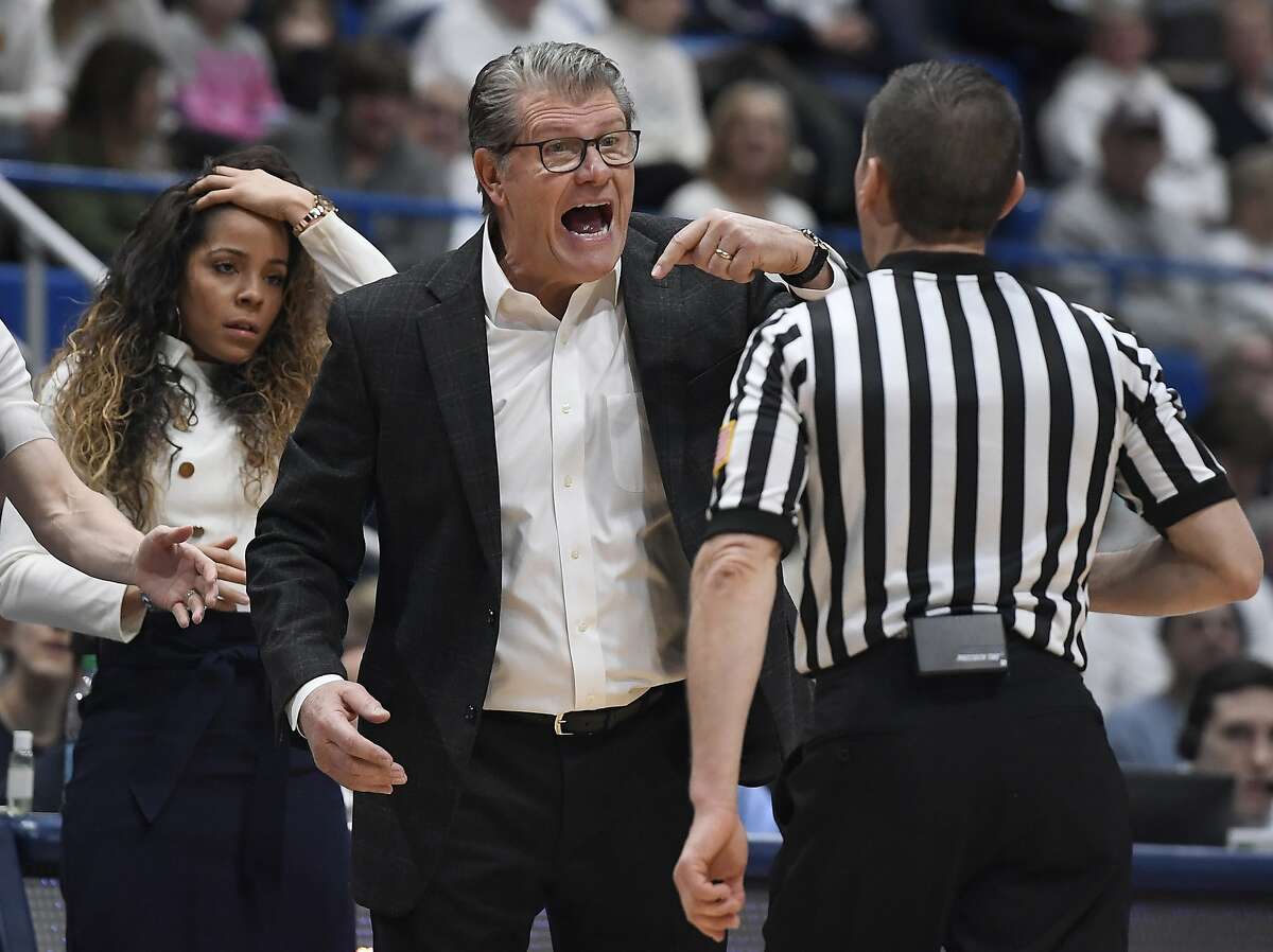 Connecticut head coach Geno Auriemma reacts toward official Joseph Vaszily, right, as assistant coach Jasmine Lister, left, looks on, during the second half of an NCAA college basketball game against South Carolina, Monday, Feb. 11, 2019, in Hartford, Conn. (AP Photo/Jessica Hill)