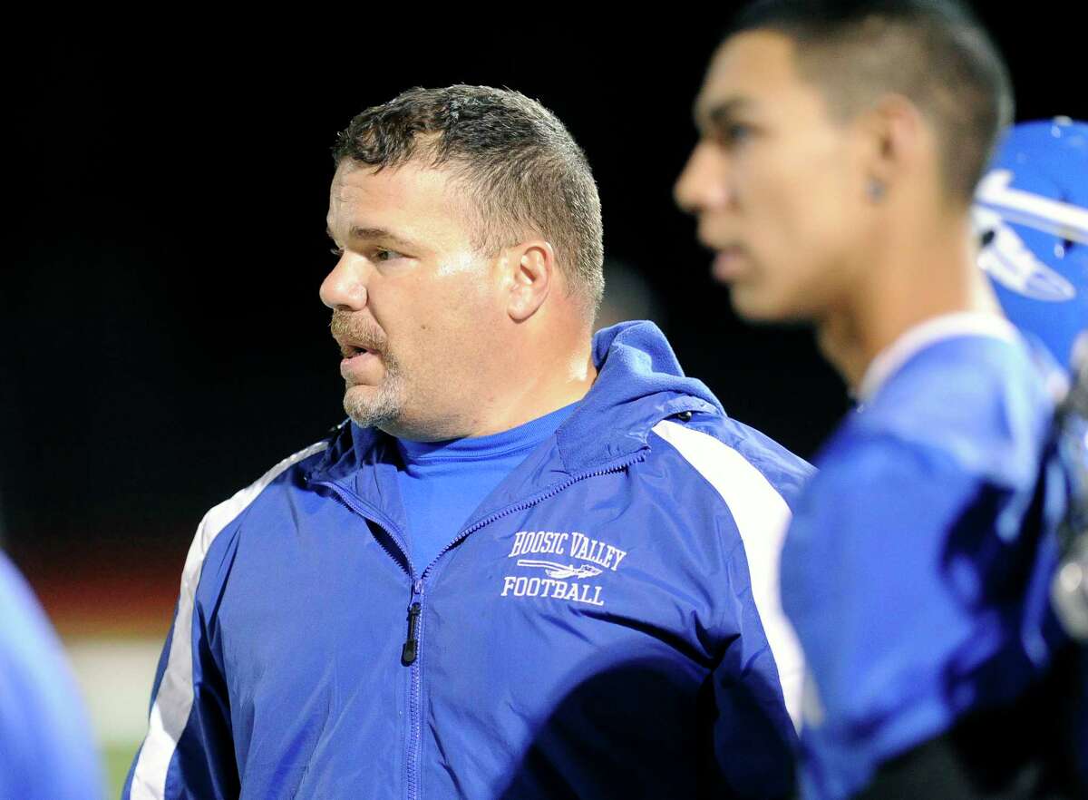 Hoosic Valley head coach Pete Porcelli ,left, instructs his players against Greenwich during their Section II Class C high school football championship game in Lansingburgh, N.Y., Friday, Nov. 6, 2015. (Hans Pennink / Special to the Times Union) ORG XMIT: HP101