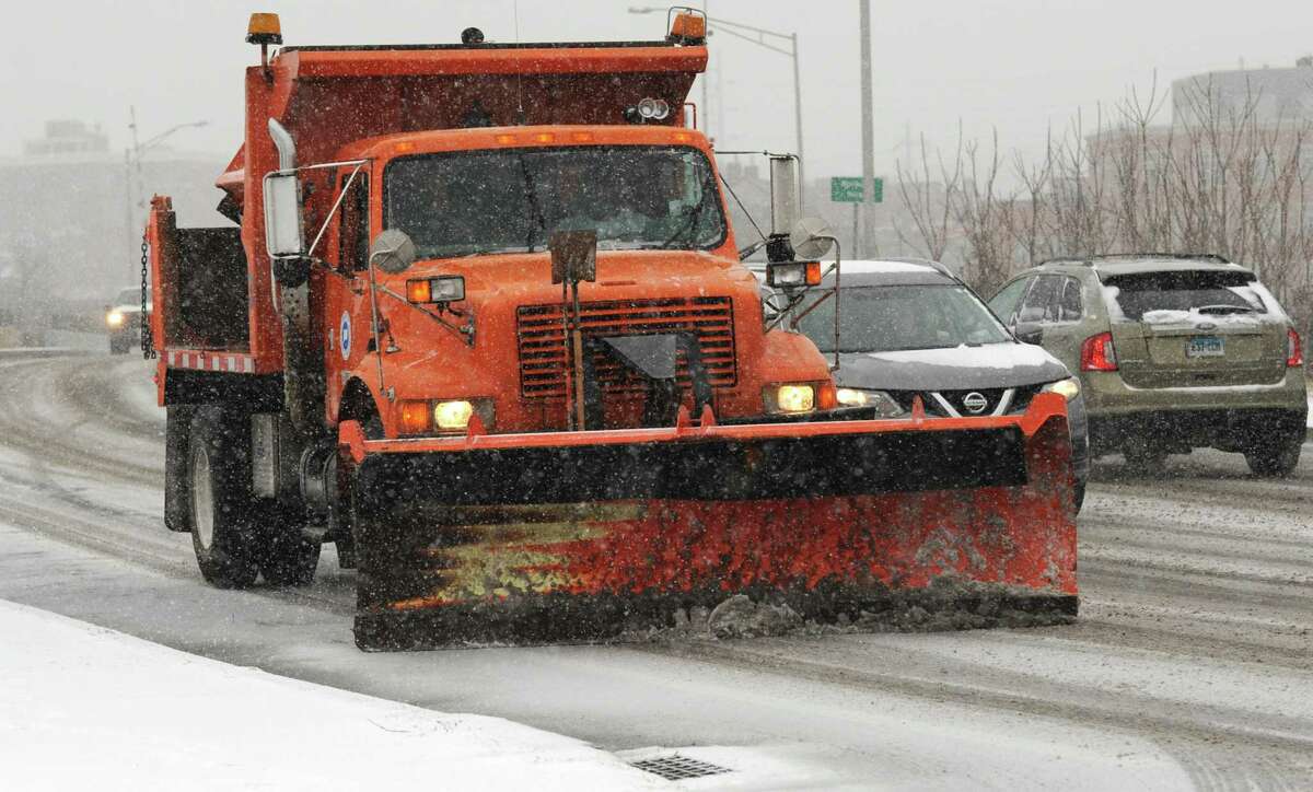 A state DOT snowplow clears the road along Fort Point Street during the snowstorm Tuesday, February 12, 2019, in Norwalk, Conn.