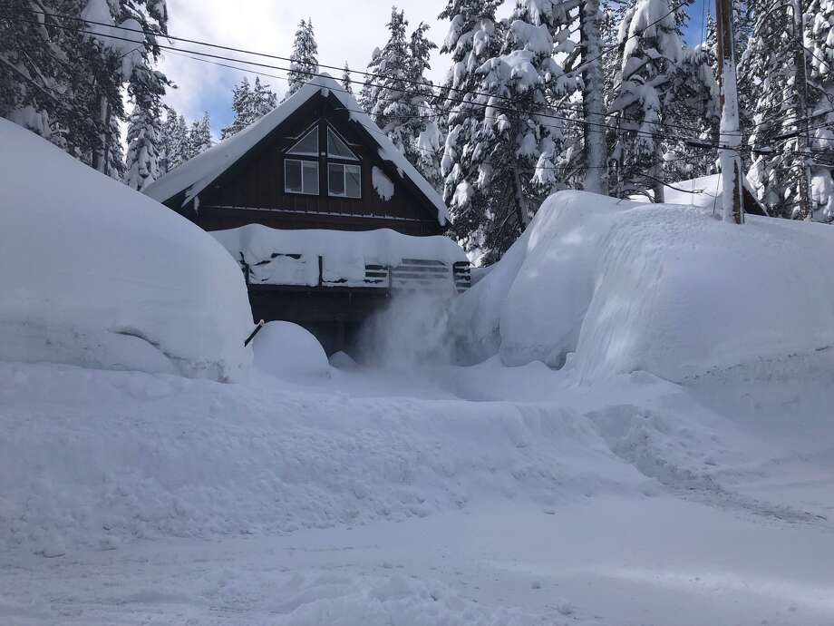 carol linburn shares photos of a snow-buried cabin near lake