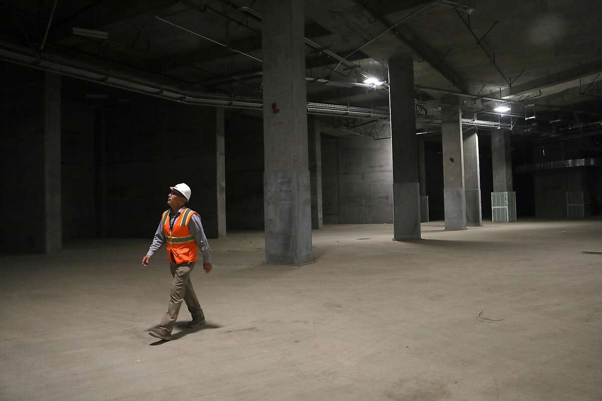 Designer engineer Skip Sowko shows the train box, a cavernous basement of the new Salesforce Transit Center, where trains will one day pull in seen on Wednesday, Aug. 8, 2018 in San Francisco, Calif.