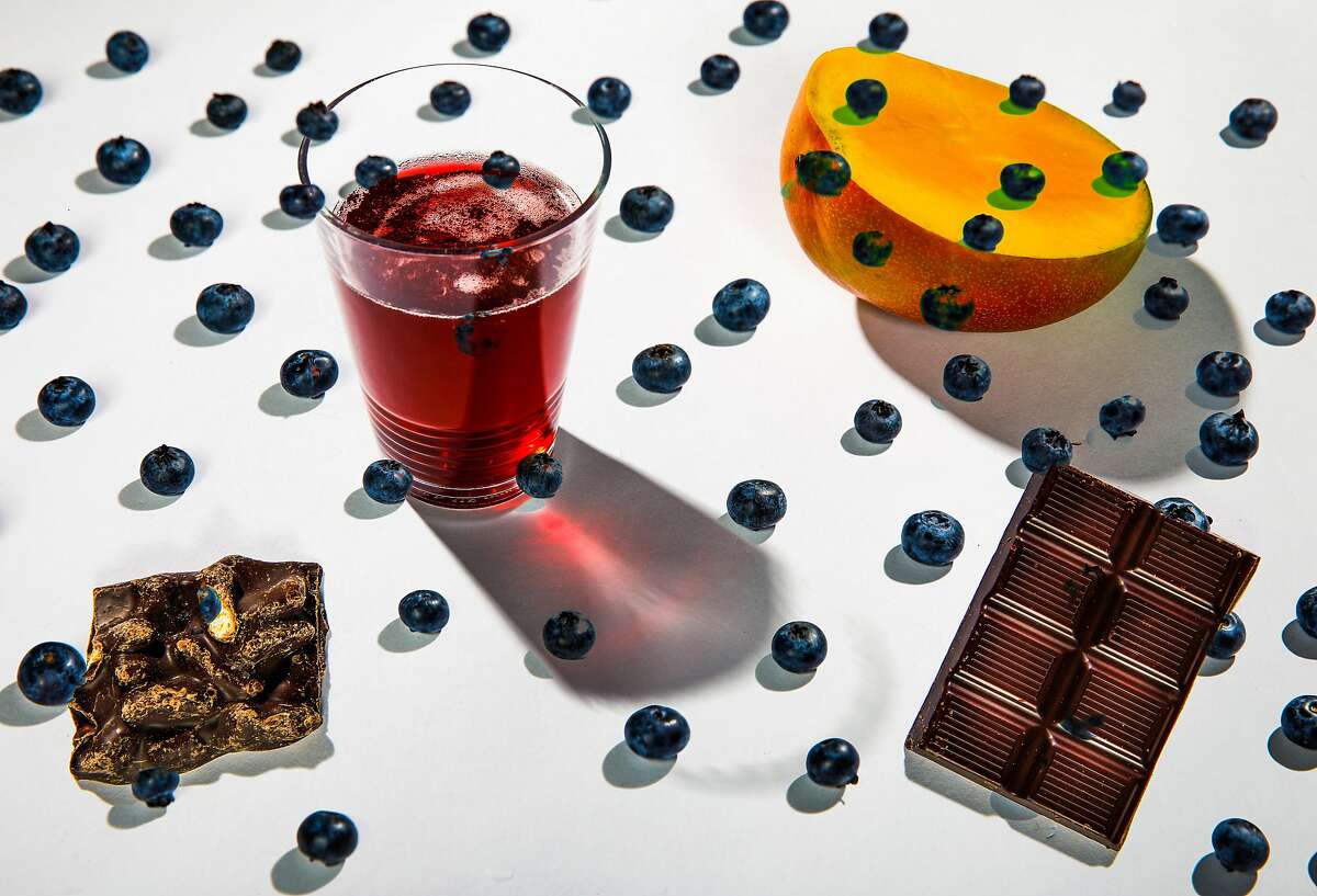 Blueberries, mangos, chocolate, pomegranate juice and beer, seen on Tuesday, Feb. 12, 2019 in San Francisco, Calif., are among foods with health benefits that should be re-examined.