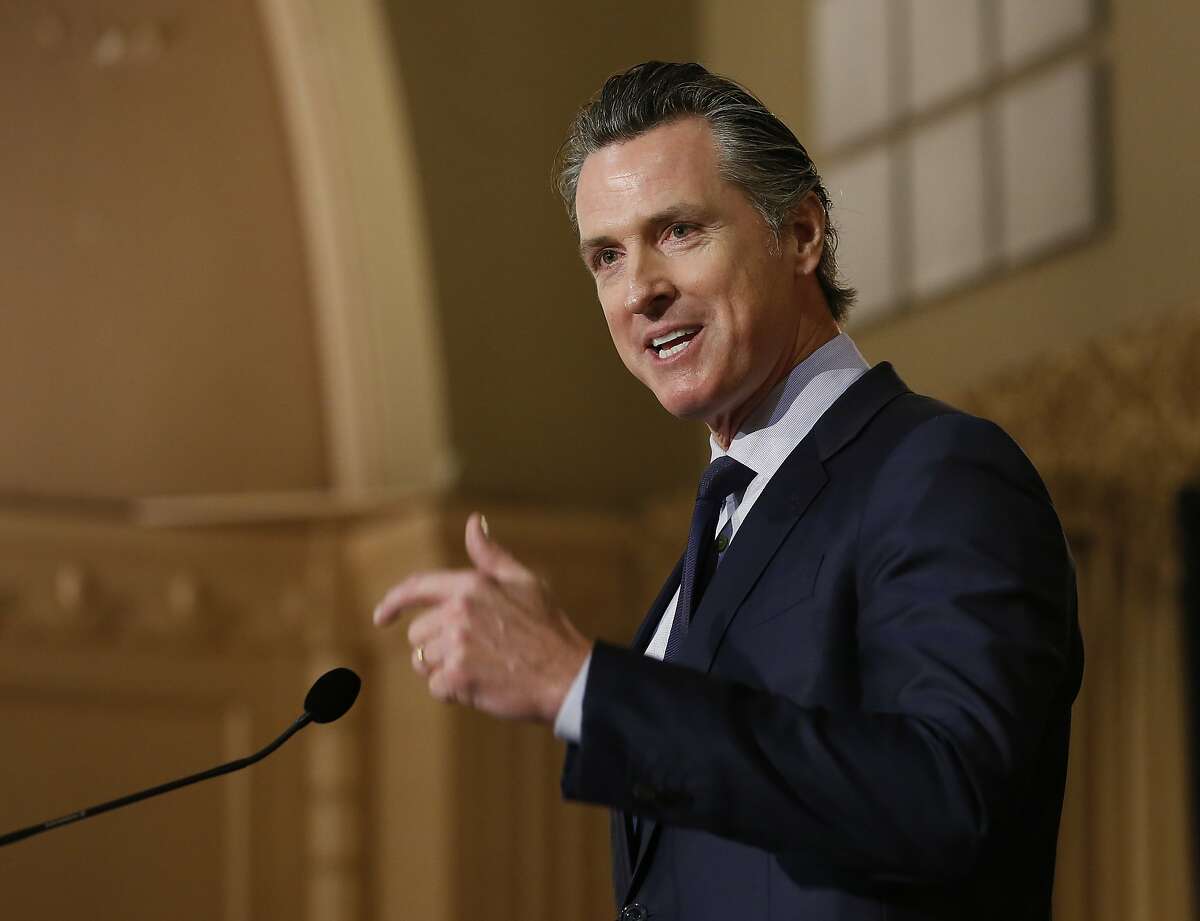 FILE - In This Jan. 17, 2019, file photo, California Gov. Gavin Newsom speaks at the California Legislative Black Caucus Martin Luther King Jr., Breakfast in Sacramento, Calif. Newsom's administration is using a new law for the first time in an attempt to force Southern California's self-styled "Surf City USA" to meet housing goals. The administration on Friday, Jan. 25, 2019, said it is suing Huntington Beach under the law that took effect Jan. 1. The measure was passed in 2017 as part of a package of bills intended to address the state's severe housing shortage and homelessness problem. (AP Photo/Rich Pedroncelli,File)