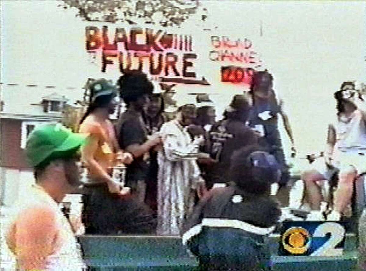 ** FILE ** A float with men in blackface reenacting the dragging death of a black man in Jasper, Texas, rolls down the parade route at the annual Labor Day parade in the community of Broad Channel in Queens, New York, Monday, Sept. 7, 1998, in this file photo from television. New York City firefighters Jonathan Walters and Robert Steiner and police officer Joseph Locurto were fired by the city for riding the float, but a judge ruled Tuesday, June 24, 2003 that the firings were a violation of the men's First Amendment rights. (AP Photo/WCBS, File)