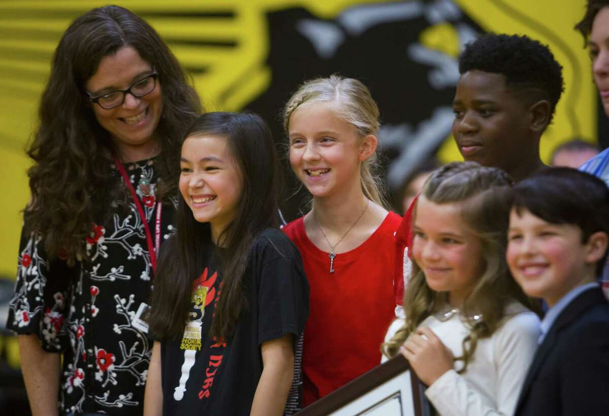 Strack Middle school students and staff pose with the stars of the TV show "Young Sheldon" at Klein Oak High School on Monday, Sept. 17, 2018. The stars visited the school to present a new STEM grant as part of an initiative to schools in both East Texas (where the show is set) and Southern California (where it 's filmed).