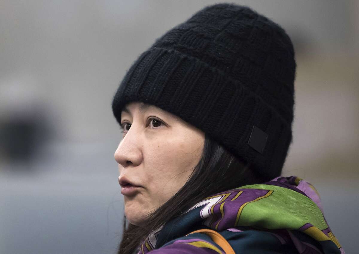 FILE - In this Dec. 12, 2018, file photo, Huawei chief financial officer Meng Wanzhou arrives at a parole office in Vancouver, British Columbia. Canada’s national game _ brought to you by China’s Huawei. As a feud deepens between Beijing and Ottawa over the telecom giant, the company’s sponsorship of the flagship “Hockey Night in Canada” broadcast raised questions about its involvement in a beloved national institution.(Darryl Dyck/The Canadian Press via AP, File)