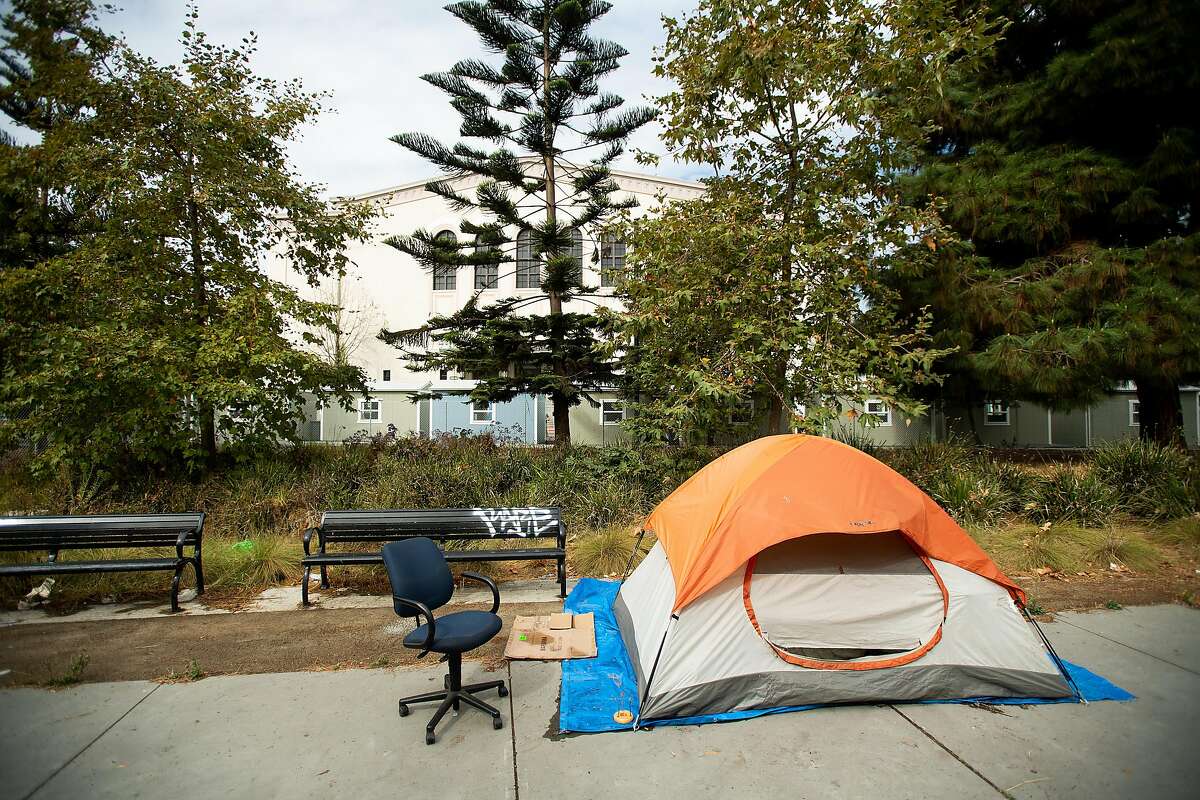 A tent rests adjacent to the Lake Merritt Community Cabins site in Oakland, Calif., on Tuesday, Oct. 2, 2018. The city plans to house up to 40 homeless people in the sheds as part of it's third Community Cabins site.