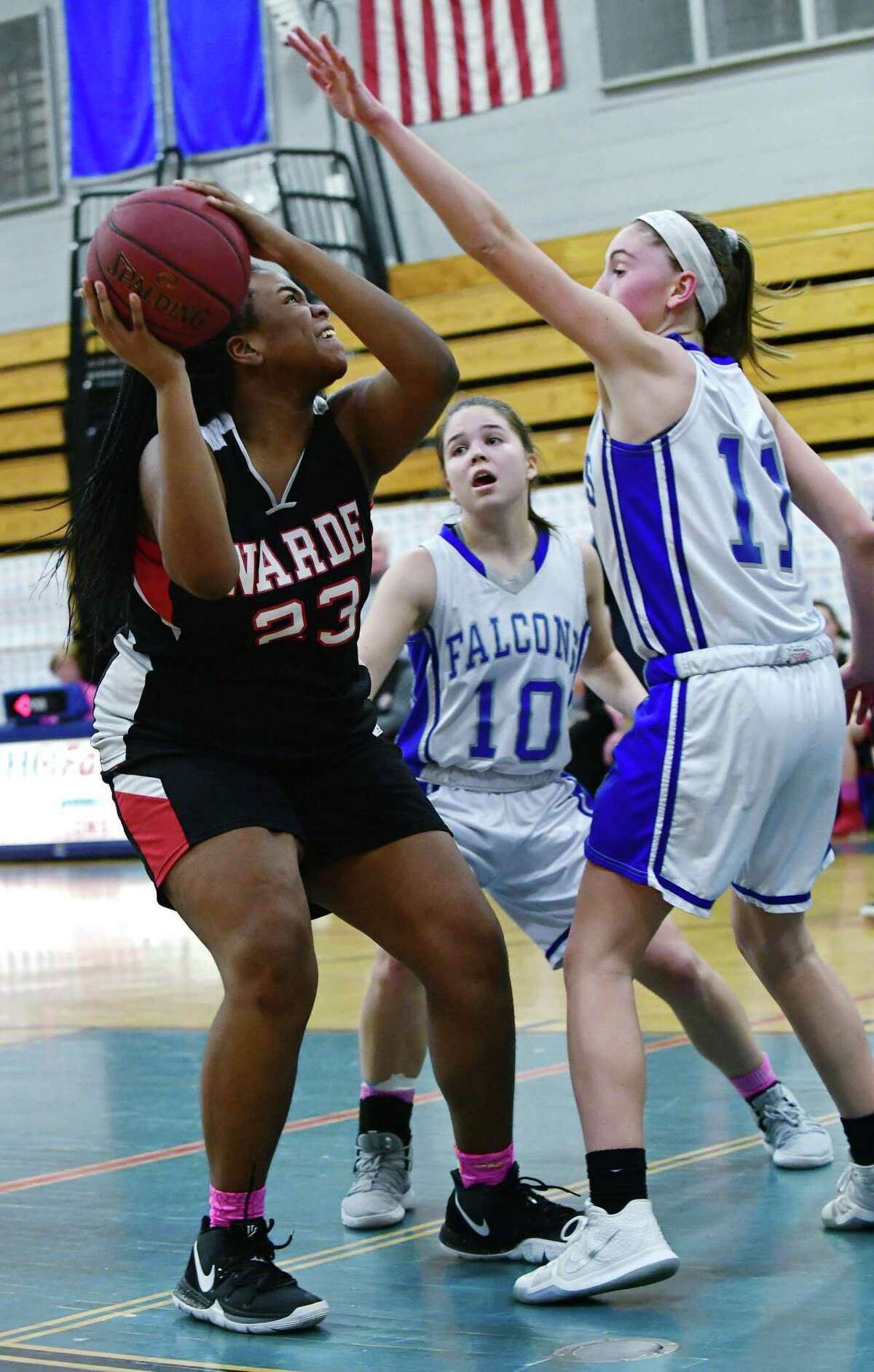 Mustang #33 Aleysha Henry goes up against Falcons #10 Juliet Bucher and #13Anna Paulmann as Fairfield Warde High School Mustangs takes on Fairfield Ludlowe High School Falcons during the FCIAC intra-city girls basketball game Wednesday, February 13, 2019, in Fairfiled, Conn.