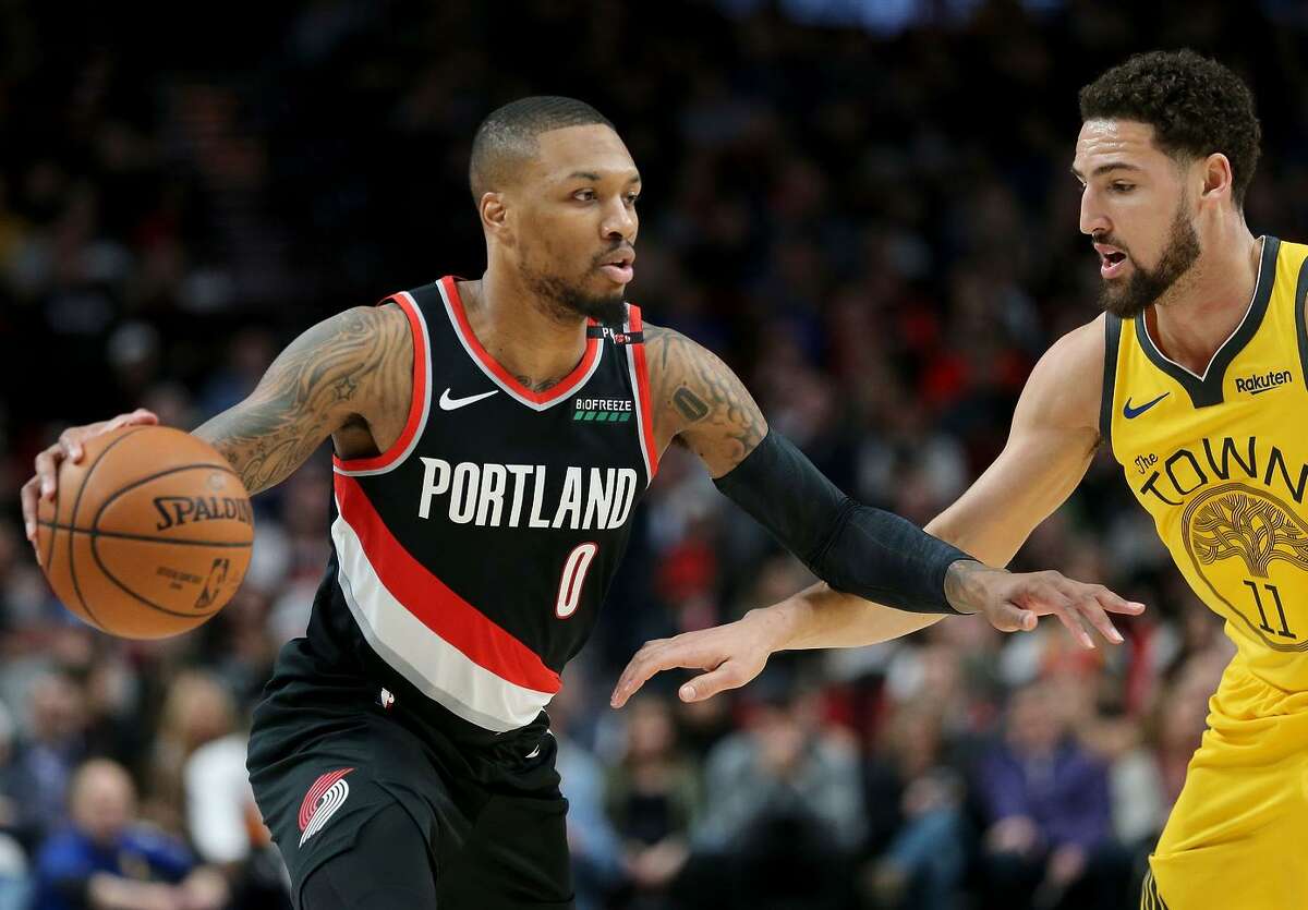 The Blazers’ Damian Lillard (0), dribbling while being guarded by the Warriors’ Klay Thompson, had 29 points in the victory, hitting 9 of 15 shots from 3-point range.