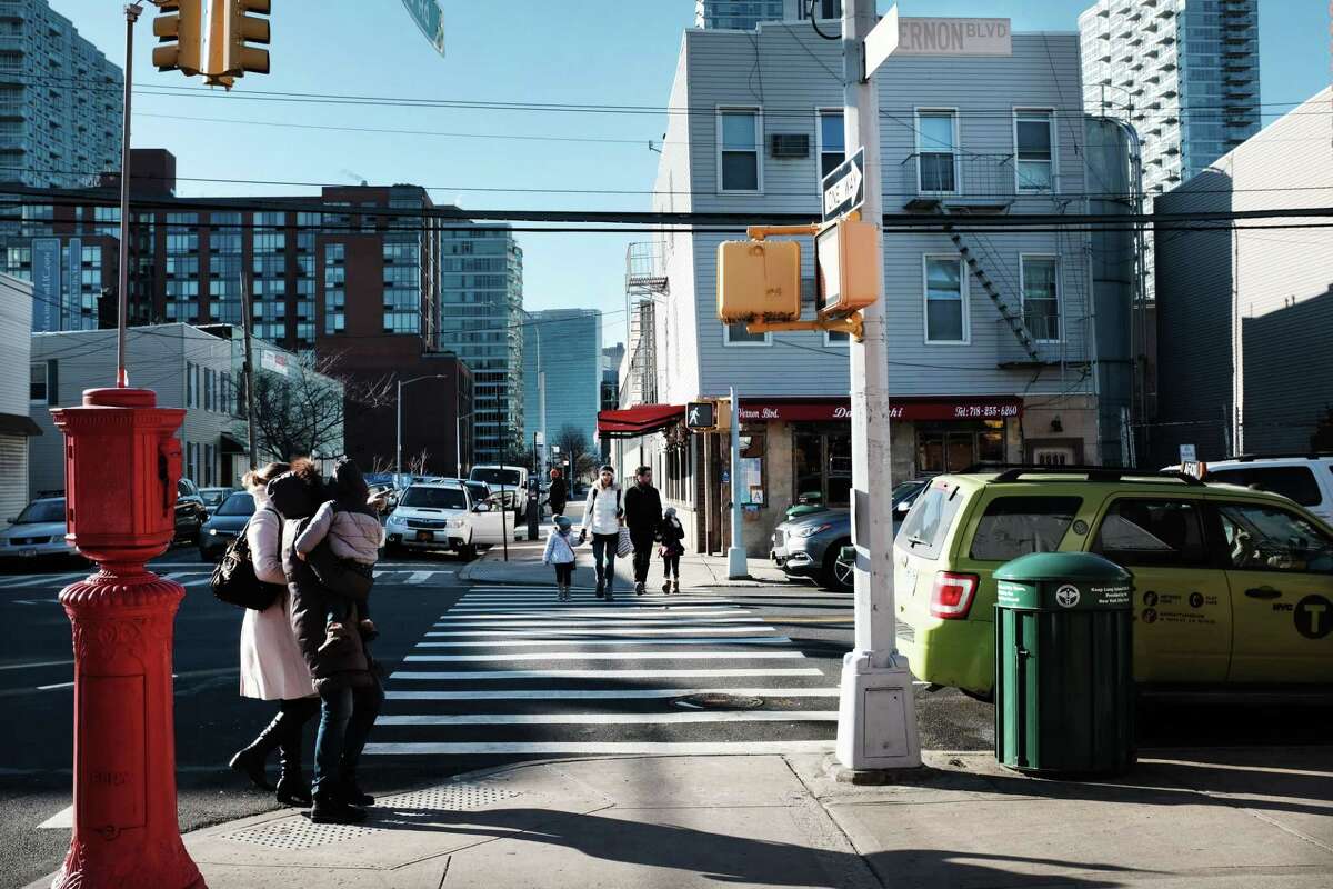 People walk through the Long Island City neighborhood on Feb. 9, 2019, in Queens, N.Y. Amazon announced on Thursday, Feb. 14 that it was abandoning its plans for a new headquarters in Long Island City.