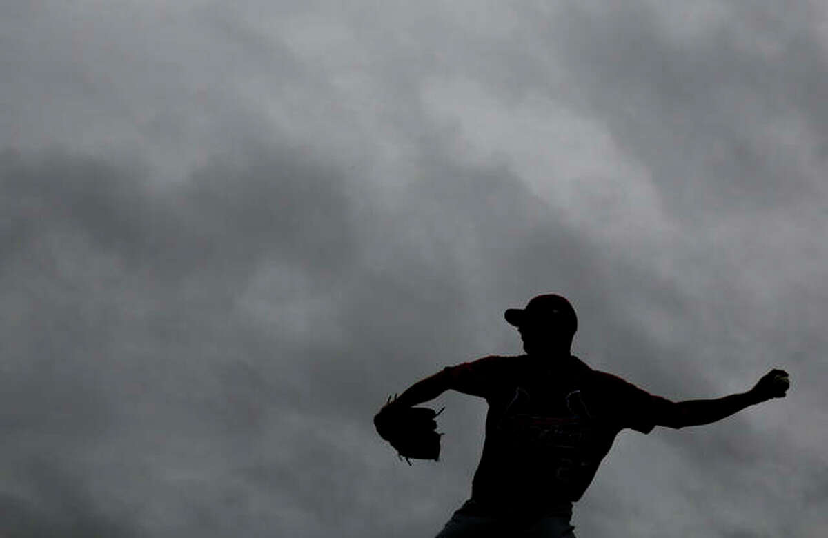 St. Louis Cardinals pitcher Brett Cecil throws a bullpen session in the rain as clouds hang overhead during spring training baseball practice Wednesday, Feb. 13, 2019, in Jupiter, Fla.