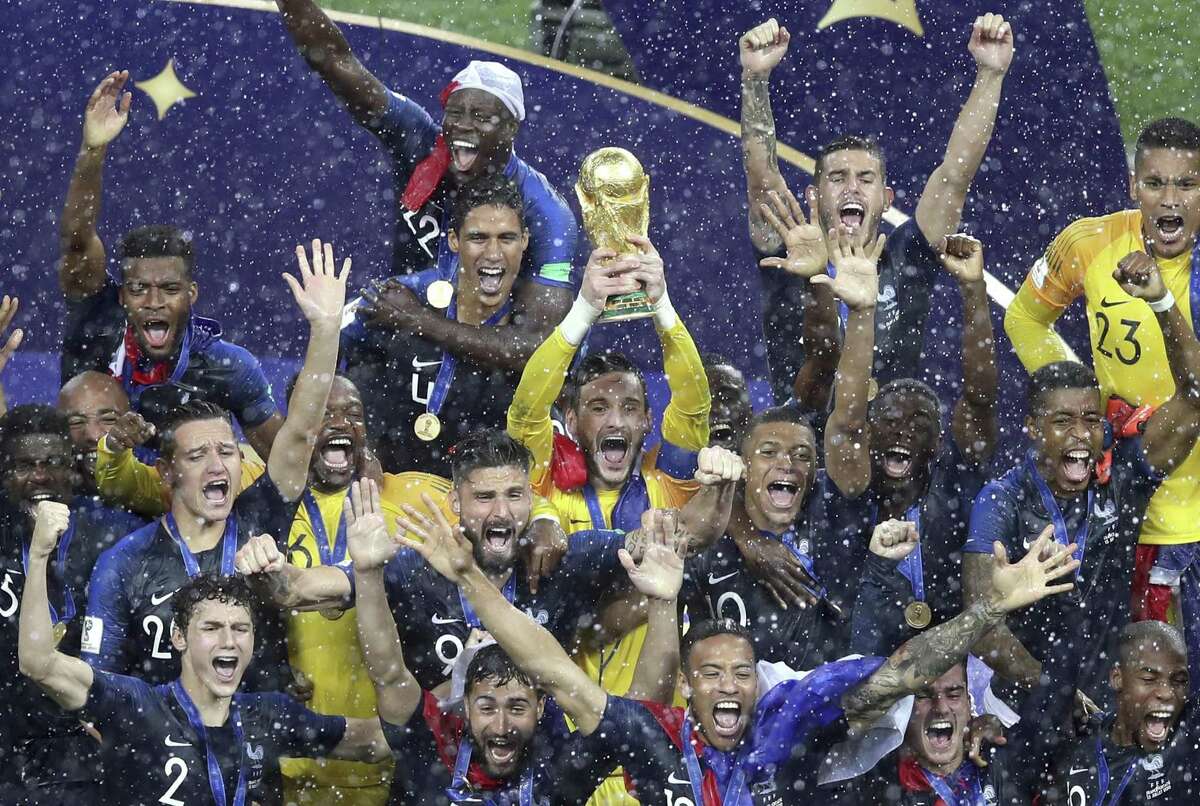 French players celebrate with the trophy at the end of the final match between France and Croatia at the 2018 soccer World Cup in the Luzhniki Stadium in Moscow, Russia, Sunday, July 15, 2018. (AP Photo/Thanassis Stavrakis)