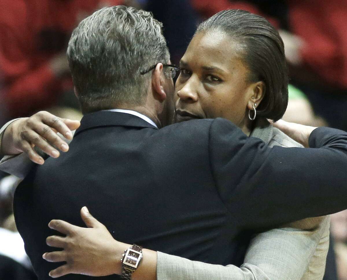 Cincinnati coach Jamelle Elliott, right, hugs UConn coach Geno Auriemma after UConn’s 86-29 win on Feb. 1, 2014 in Cincinnati.