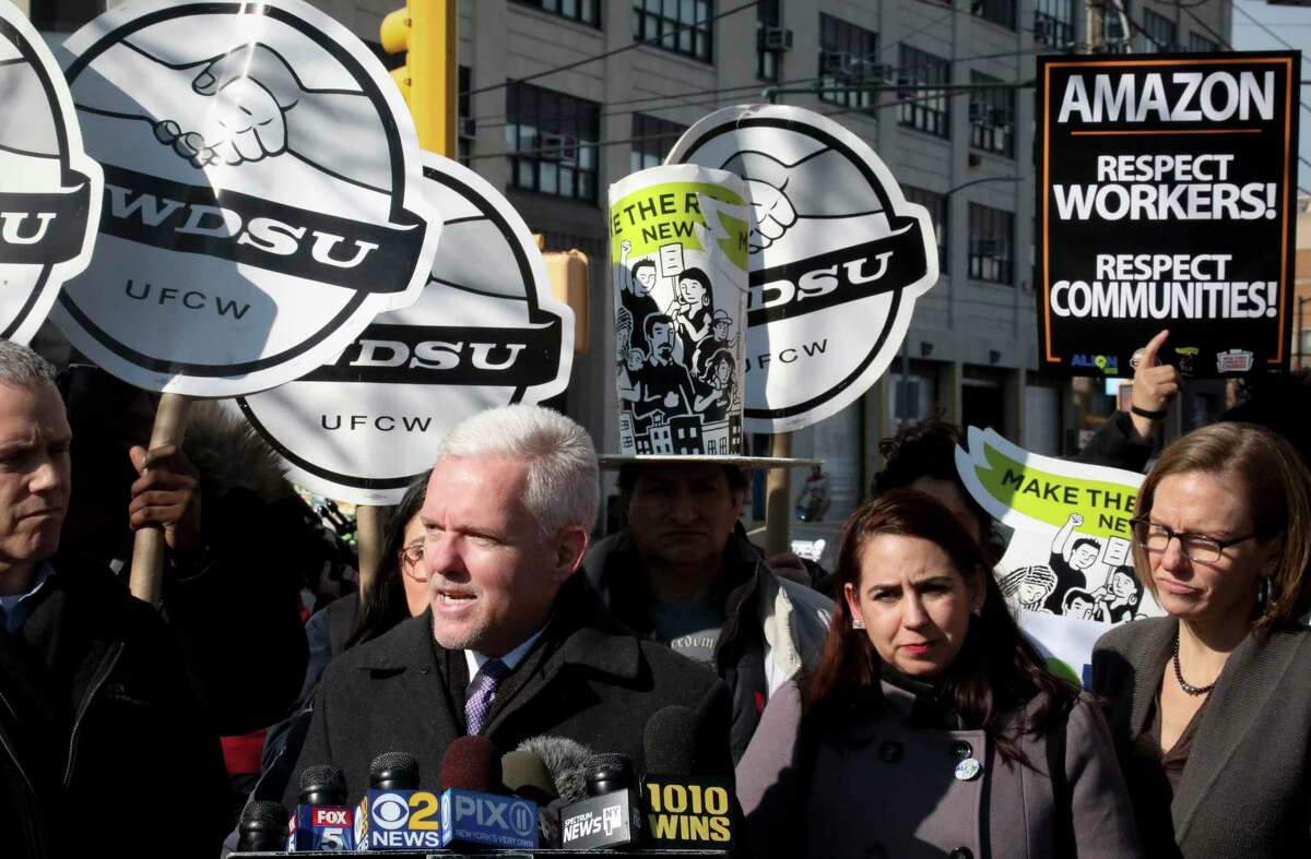 New York City Councilman Jimmy Van Bramer, second from left, speaks during a press conference in Gordon Triangle Park in the Queens borough of New York, following Amazon's announcement it would abandon its proposed headquarters for the area, Thursday Feb. 14, 2019. (AP Photo/Bebeto Matthews)