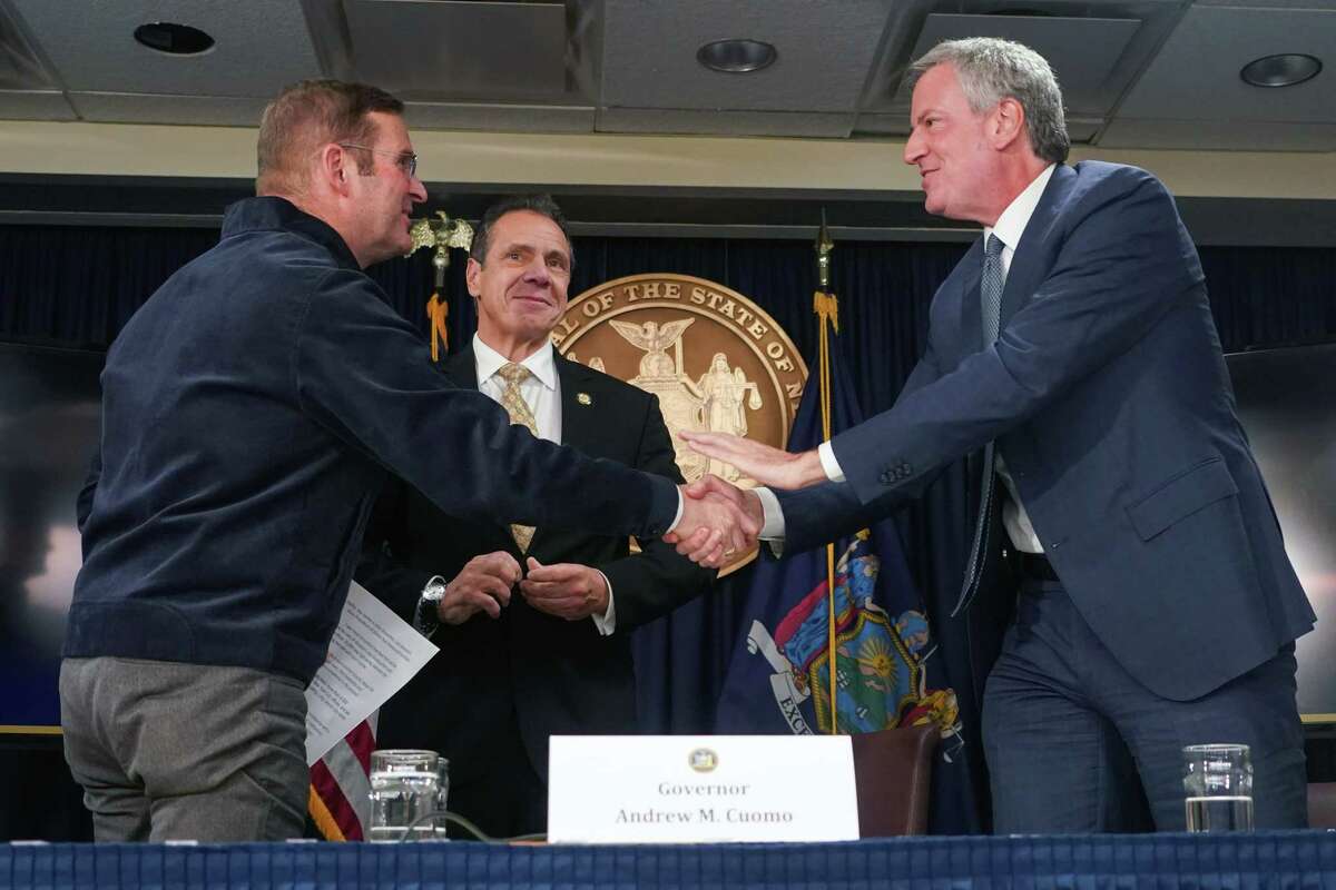 From left: John Schoettler, Amazon's vice president for global real estate and facilities; Gov. Andrew Cuomo; and Mayor Bill de Blasio at a news conference in New York, Nov. 13, 2018. Amazon?’s sudden decision on Feb. 14, 2019, to cancel its plan to build a corporate campus in Long Island City, Queens, amounted to a stunning rejection for the two often-at-odds politicians who had heralded its arrival, Cuomo and de Blasio, and the biggest win yet for emboldened left-wing progressives in New York. (Chang W. Lee/The New York Times)