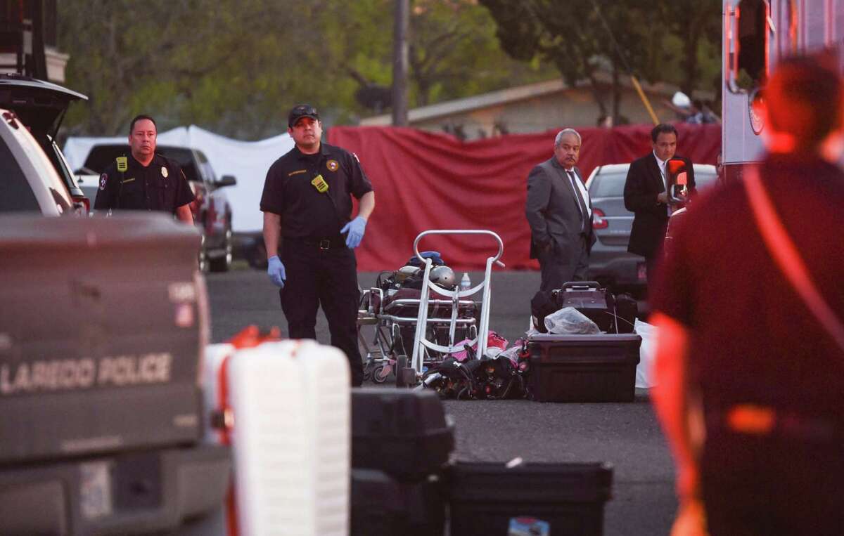 Laredo firefighters look on after human remains were found inside a bucket at an apartment Thursday at Santa Rita Avenue and Jefferson Street.