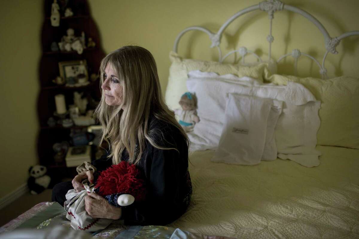 Gwen Casados sits in her daughter’s room in Houston. Her daughter, Heather Schneider, was sexually assaulted inside Second Baptist Church in Houston in 1993.