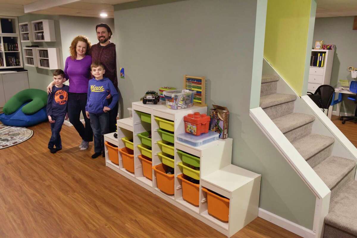 Leigh Hornbeck and her husband, Josh Trombley pose for a photo in their finished basement with their two sons, Devlin Trombley, 6, left, and Rushton Trombley, 9, on Tuesday, Feb. 12, 2019, in Gansevoort, N.Y. (Paul Buckowski/Times Union)