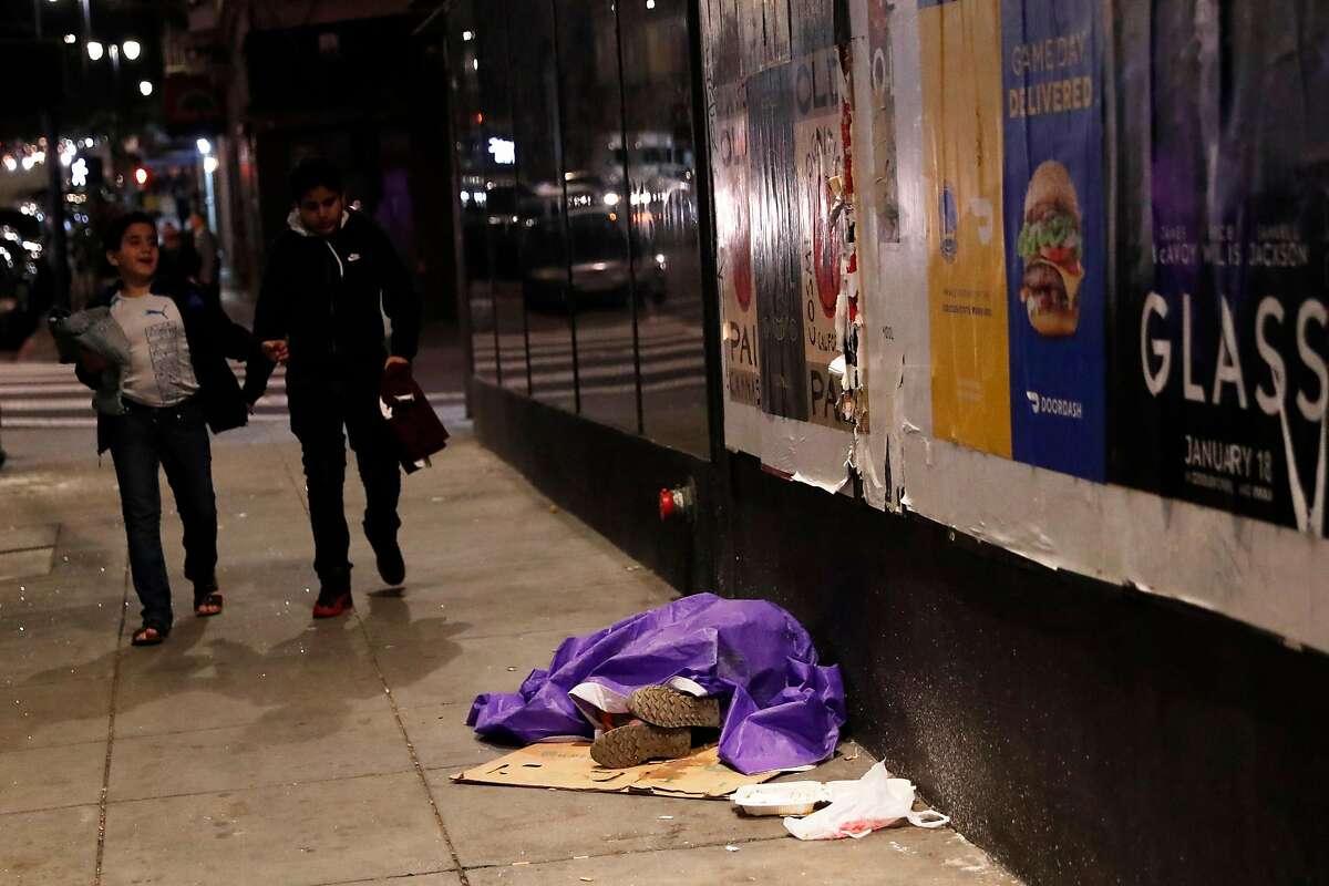 A homeless person sleeps on Hyde Street during 2019 Homeless Point-In-Time Count in San Francisco, Calif., on Thursday, January 24, 2019.