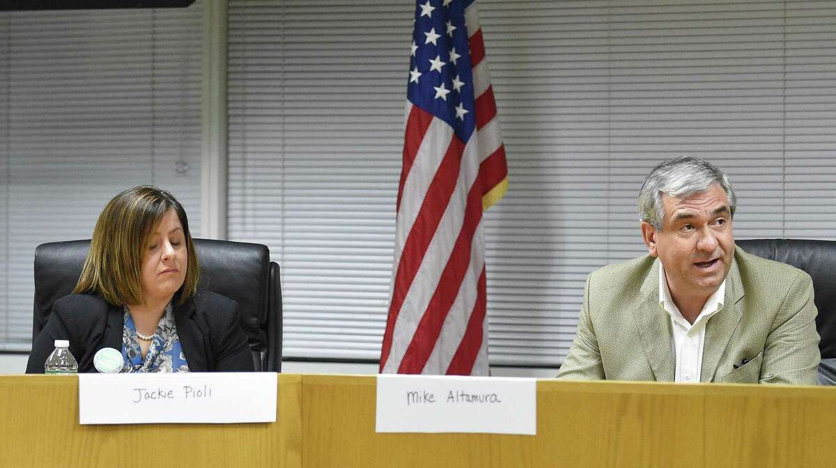 Members of the Stamford Board of Education, including Jackie Pioli (L) and Mike Altamura (R) voted on the school board budget for the 2019-2020 school year on Feb. 14, 2019 in Stamford, Conn.
