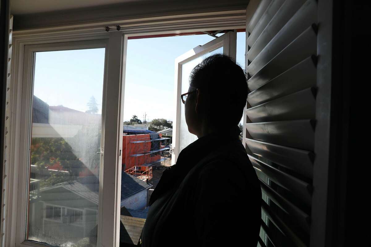 Sandra Montgomery looks out a window in her home onto the construction site of Glenview Elementary School on Tuesday, February 5, 2019 in Oakland, Calif.