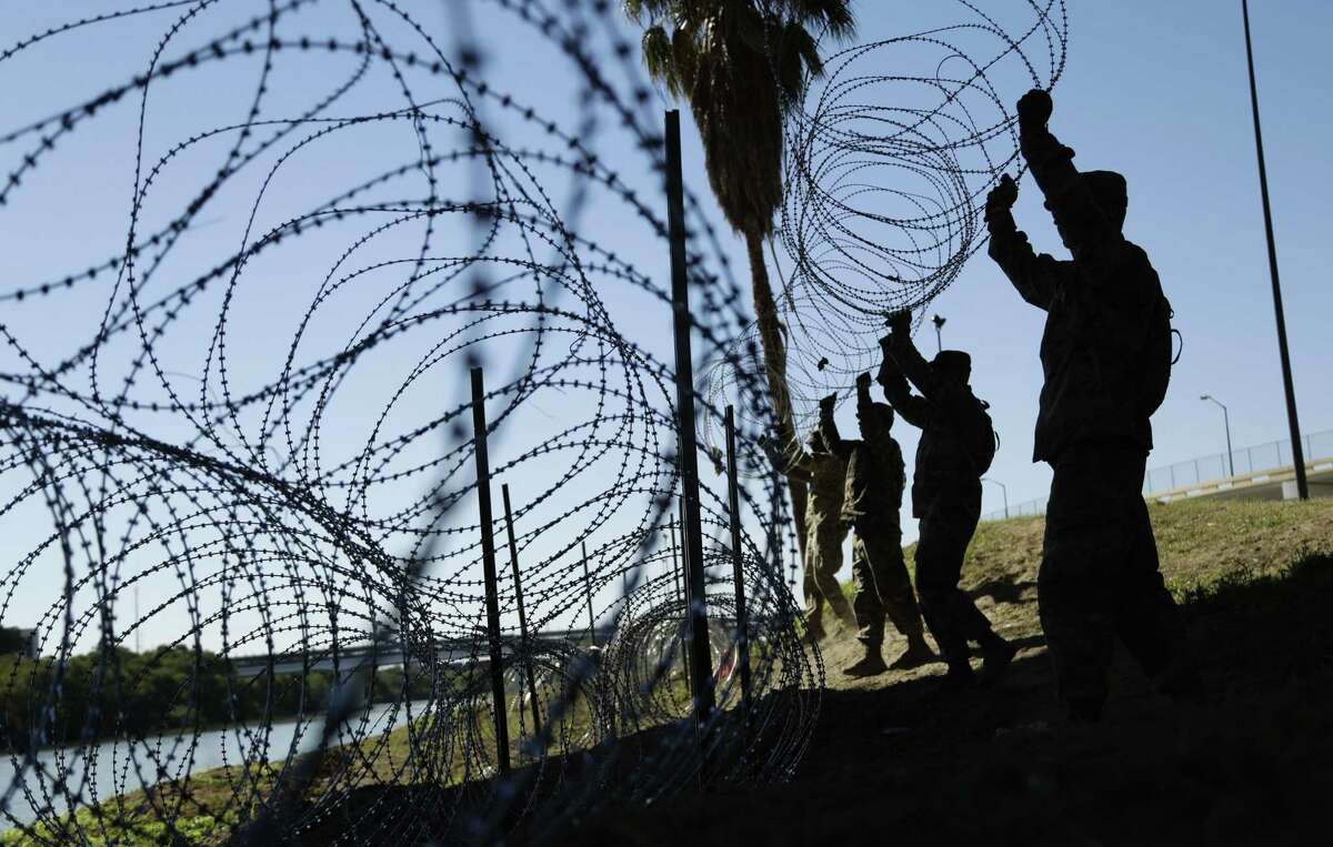 The U.S. military installs multiple tiers of concertina wire along the Texas banks of the Rio Grande in November in Laredo.