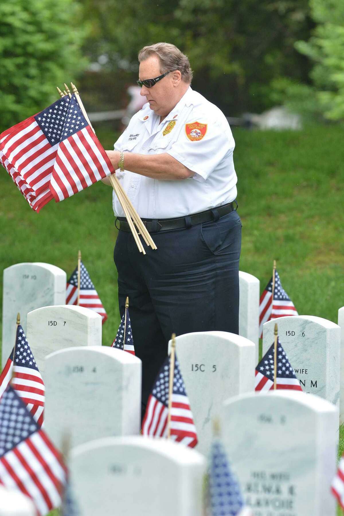 Deputy Chief and Fire Marshal Steven Krol joined of the South Fire District to help local veterans place American Flags at over 6,000 headstones at the Connecticut State Veterans Cemetery at 317 Bow Lane in Middletown on May 23, 2014.