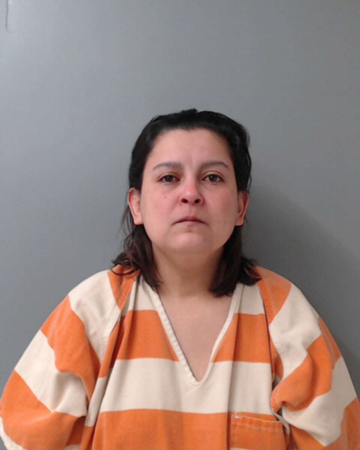 Monica Dominguez, 37, was charged with abuse of a human corpse, a state jail felony, tampering with or fabricating physical evidence by altering, destroying or concealing a human corpse, a second-degree felony and two counts of endangering a child.