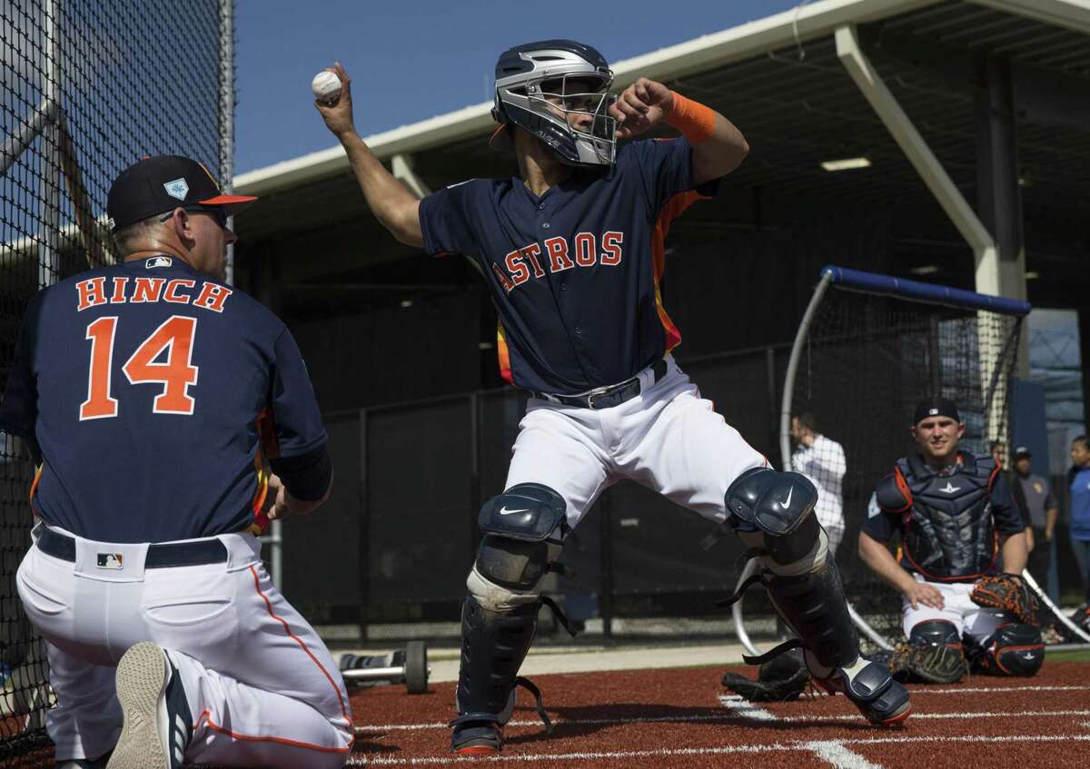 Houston Astros manager AJ Hinch (14) coaches catcher Robinson Chirinos throwing the ball to second base at Fitteam Ballpark of The Palm Beaches on Day 2 of spring training on Friday, Feb. 15, 2019, in West Palm Beach.