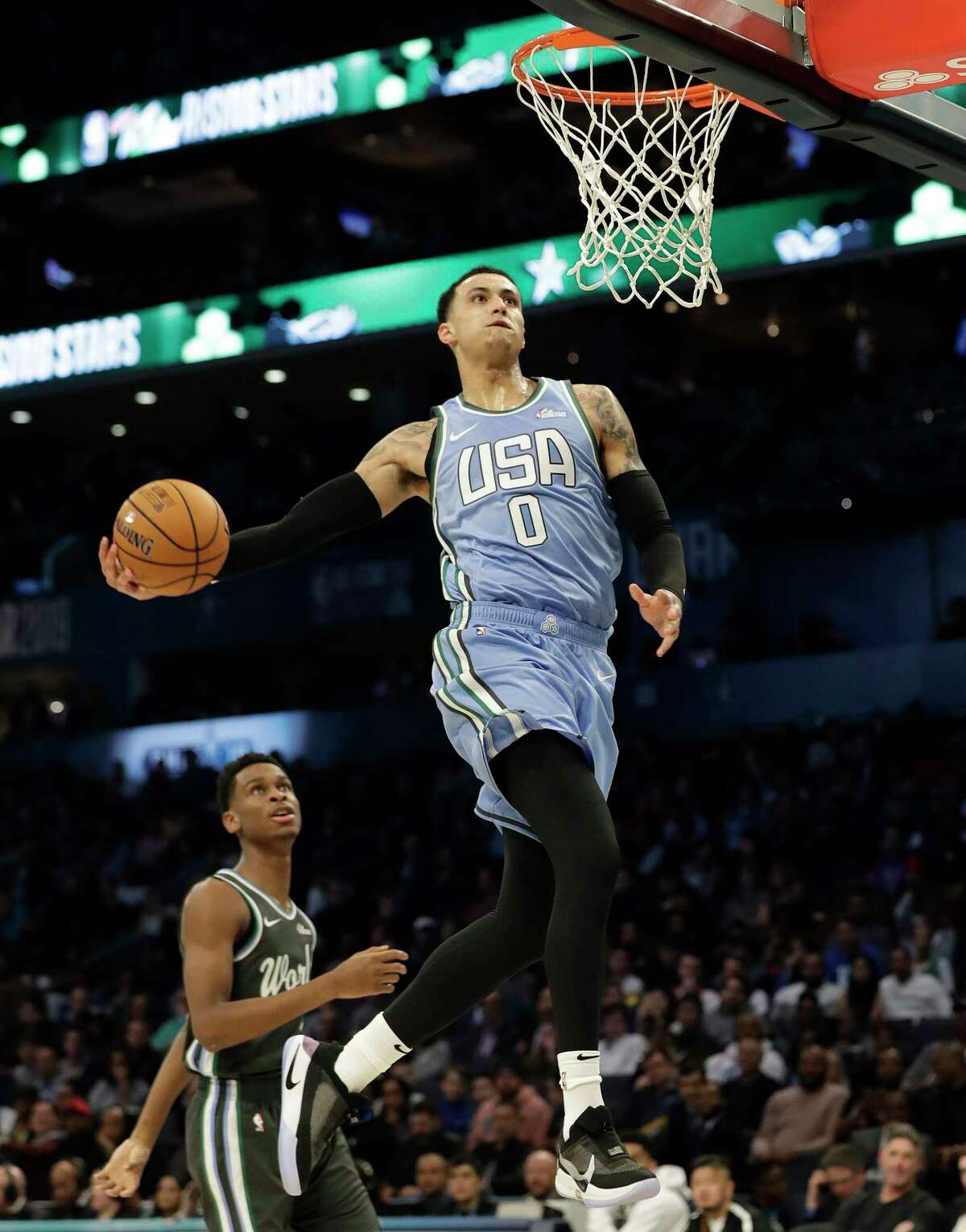 U.S. Team's Kyle Kuzma, of the Los Angeles Lakers heads to the hoop for a dunk against the World Team during the NBA All-Star Rising Stars basketball game, Friday, Feb. 15, 2019, in Charlotte, N.C. (AP Photo/Chuck Burton)