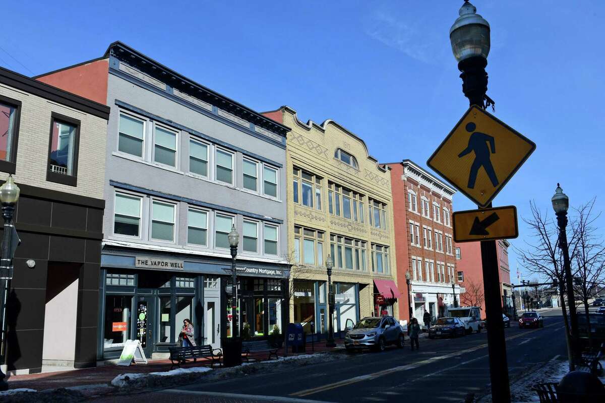 Pedstrians walk along Washington Street Thursday,, February 14, 2019, in Norwalk, Conn. Norwalk is competing with other cities in the region to lure millennials.