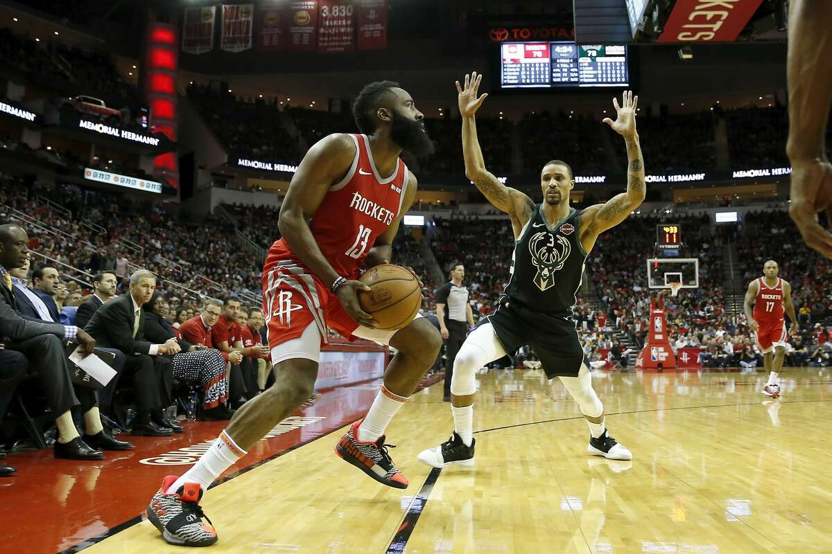 HOUSTON, TX - JANUARY 09: James Harden #13 of the Houston Rockets steps back for a three point shot defended by George Hill #3 of the Milwaukee Bucks in the second half at Toyota Center on January 9, 2019 in Houston, Texas.  (Photo by Tim Warner/Getty Images)