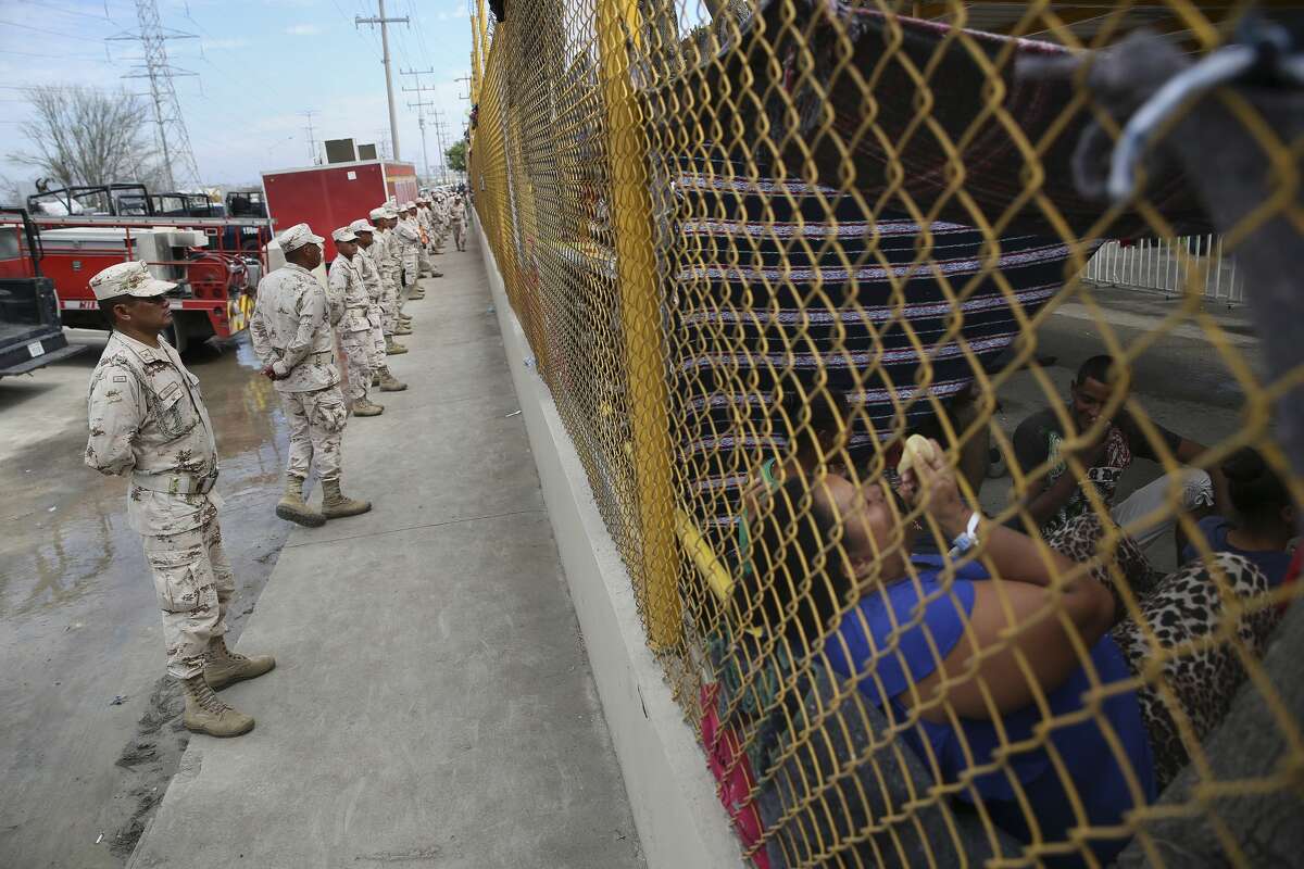 Mexican military personnel guard a shelter housing over 1,900 Central American immigrants in Piedras Negras, Mexico, Wednesday, Feb. 6, 2019. The immigrants arrived in the border town on Monday. Most are looking to seek asylum in the U.S. The town is across the Rio Grande from Eagle Pass, Texas.