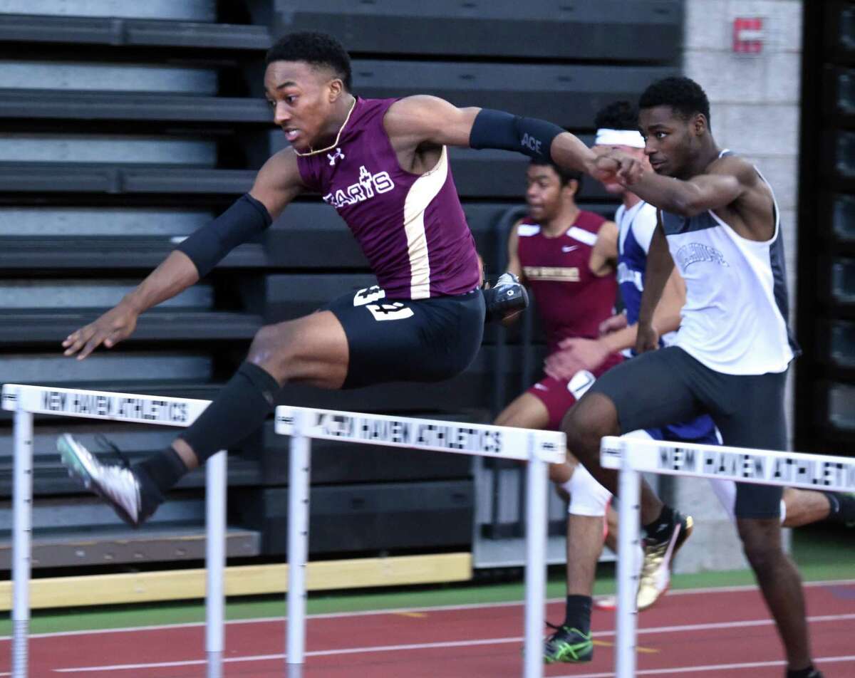 Sacred Heart’s Edward Williams, Jr., left runs to a first-place finish in the 55 meter hurdles.