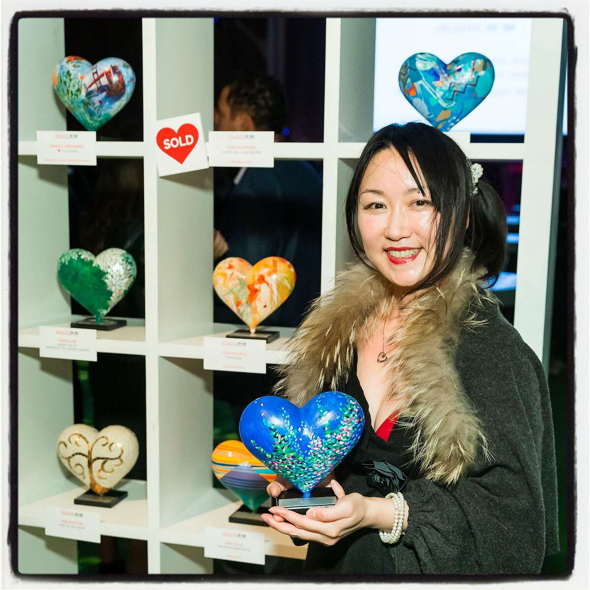 "Hearts in SF" artist Taiko Fujimura with her sculpture at Pier 48. Feb. 13, 2019.