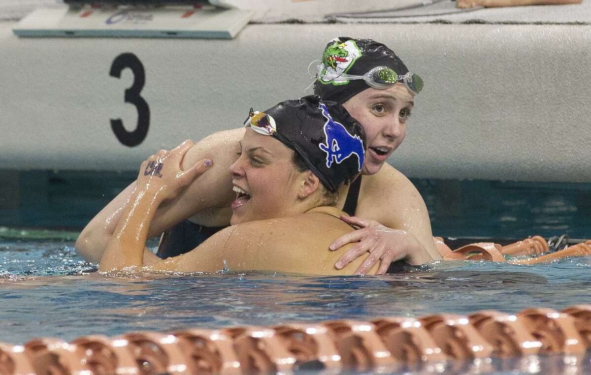 Emma Sticklen of Katy Taylor, bottom, reacts after winning the Class 6A girls 100-yard butterfly during the UIL State Swimming & Diving Championships.