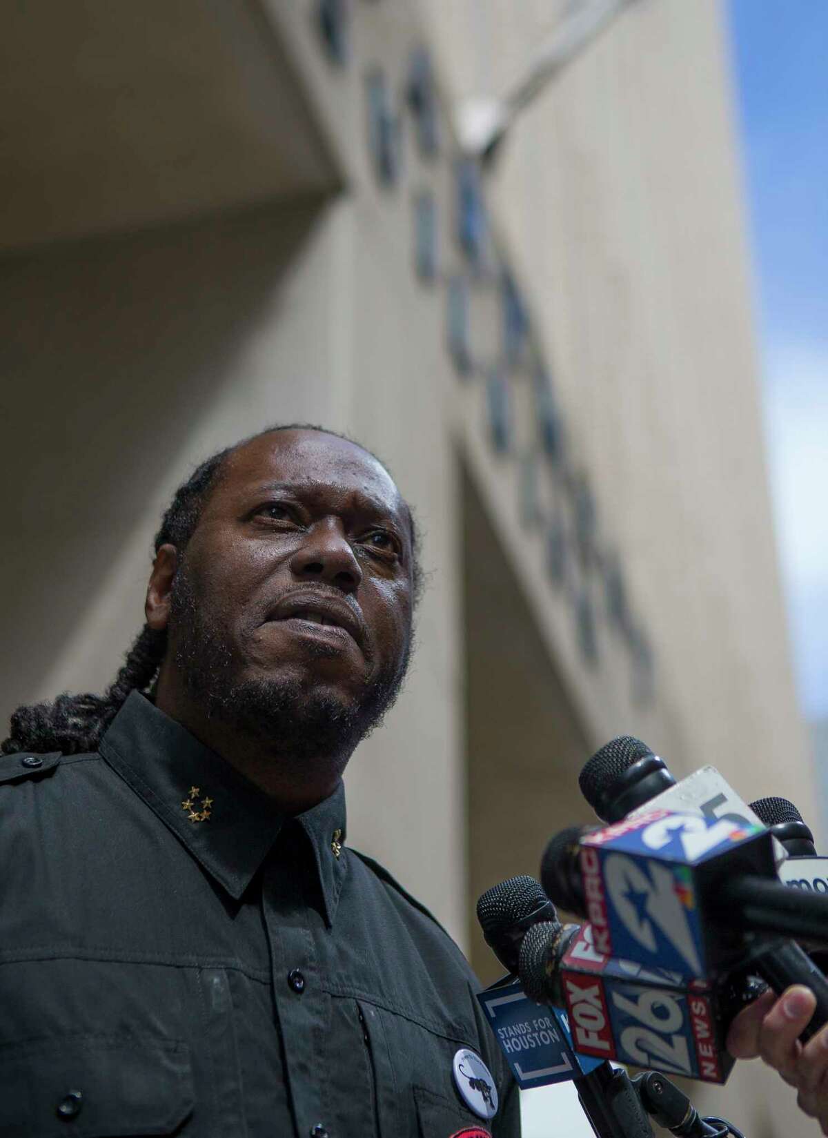 Yahcanon Ben Yah, with The People's New Black Panther Party, addresses the media in front of the Houston Police Department headquarters building in downtown Houston, Monday, Feb. 18, 2019. Activists said they were calling for police accountability and a murder charge the narcotics agent accused of fabricating evidence used to justify a no-knock raid that left two civilians dead.
