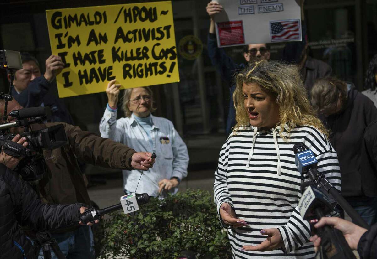 Black Lives Matter activist Shere Dore address the media as protestors gather in front of the Houston Police Department headquarters building in downtown Houston, Monday, Feb. 18, 2019. The activists said they were calling for police accountability and a murder charge the narcotics agent accused of fabricating evidence used to justify a no-knock raid that left two civilians dead.