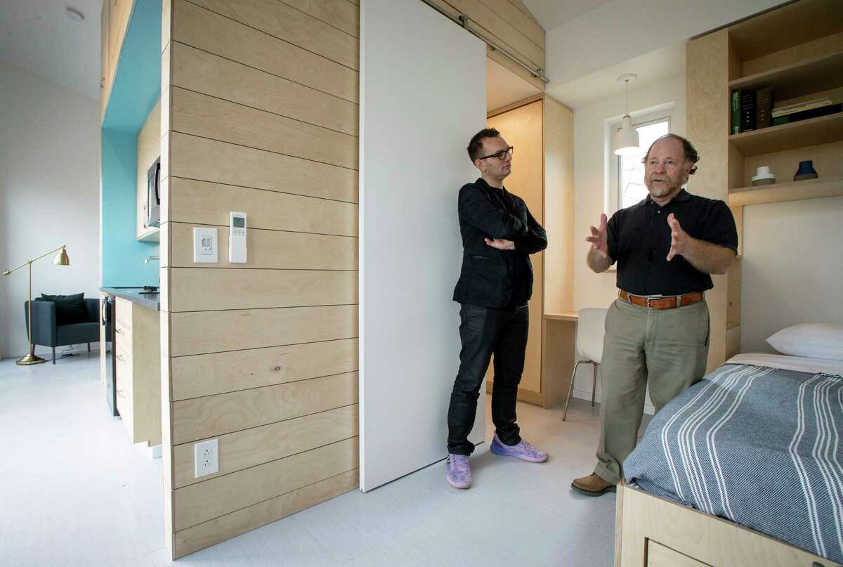Andrew Colopy, left, an assistant professor at Rice University, and Danny Samuels, a professor in practice at Rice, give a tour of an accessory dwelling unit built by their architecture students for Agape Development, which works in a small neighborhood to improve housing.