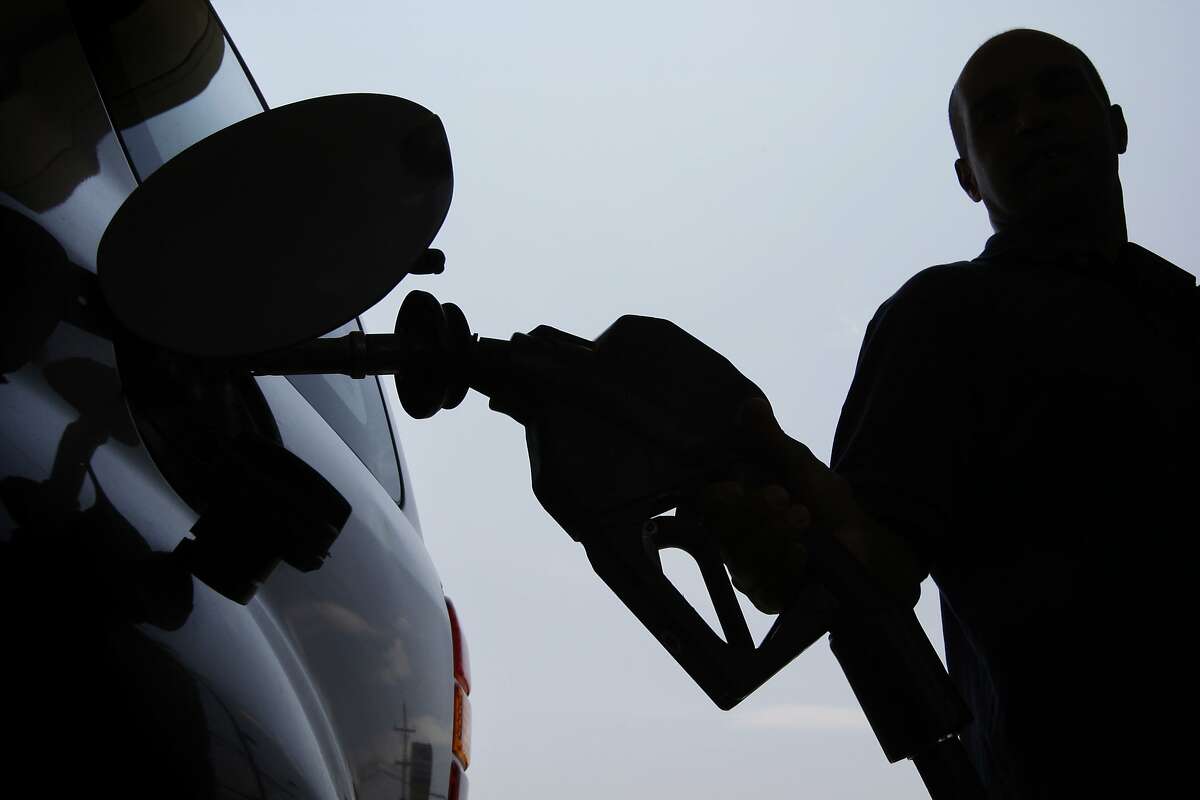 In this June 27, 2008 file photo, a person pulls a gas pump from his vehicle after filling his tank in Philadelphia. The nation's psyche is battered and bruised, the sense of pessimism palpable. The Independence Day holiday is typically a time to honor all that we are as a nation, but the feeling is there's less to celebrate on this our 232nd birthday. Happy? It would seem not. (AP Photo/Matt Rourke, file)