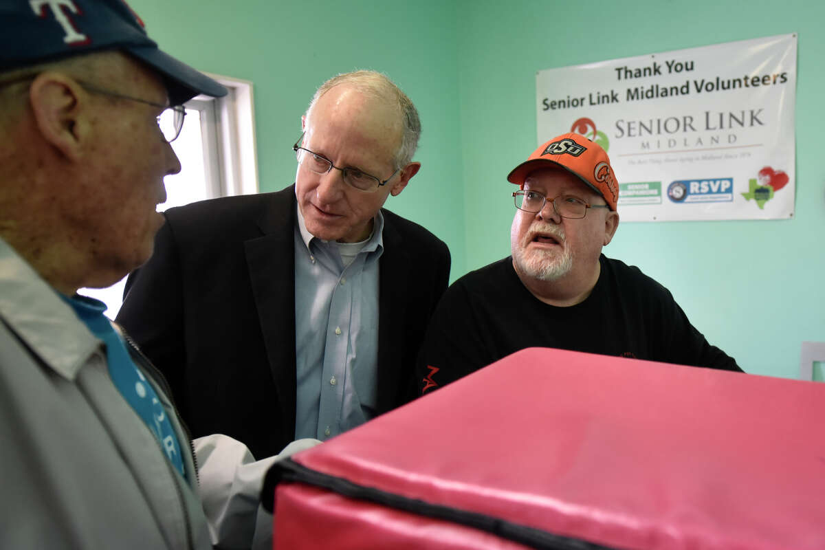 Congressman Mike Conaway visits with Gary Gililland, left, and Rocky Dean, right, volunteers for Senior Life and Meals on Wheels in this file photo from 2019.