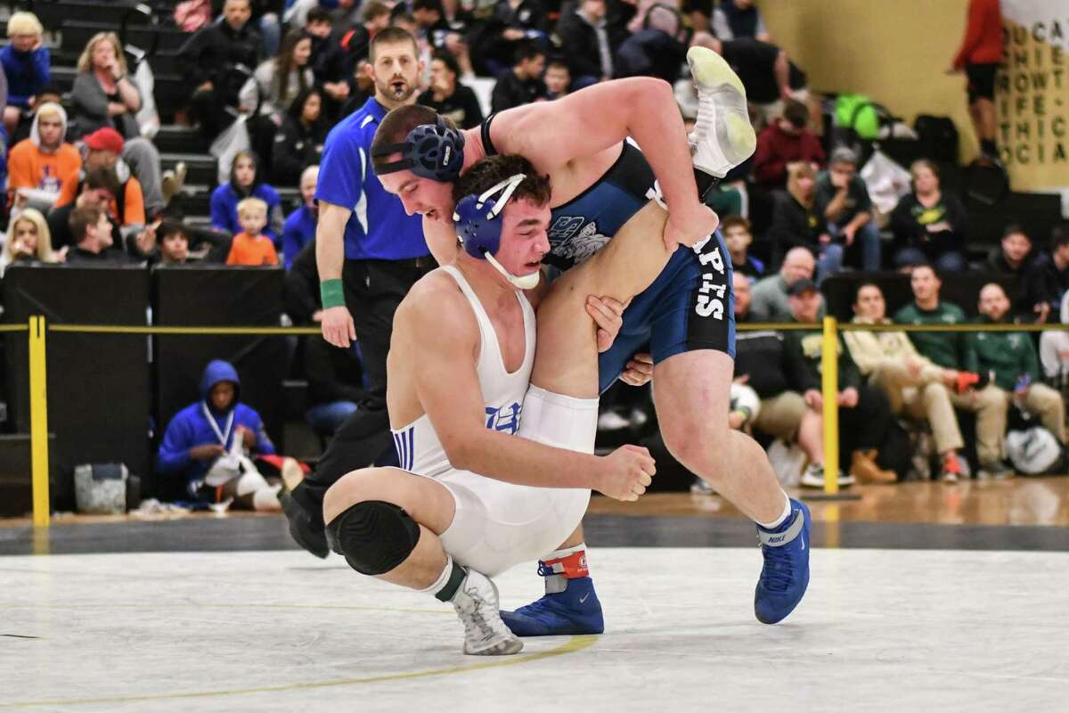 George Harrington of the Staples Wreckers and Hugh Well of Hall wrestle in the 220lb weight class during the CIAC Class LL finals on Saturday February 16, 2019 at Trumbull High School in Trumbull, Connecticut.