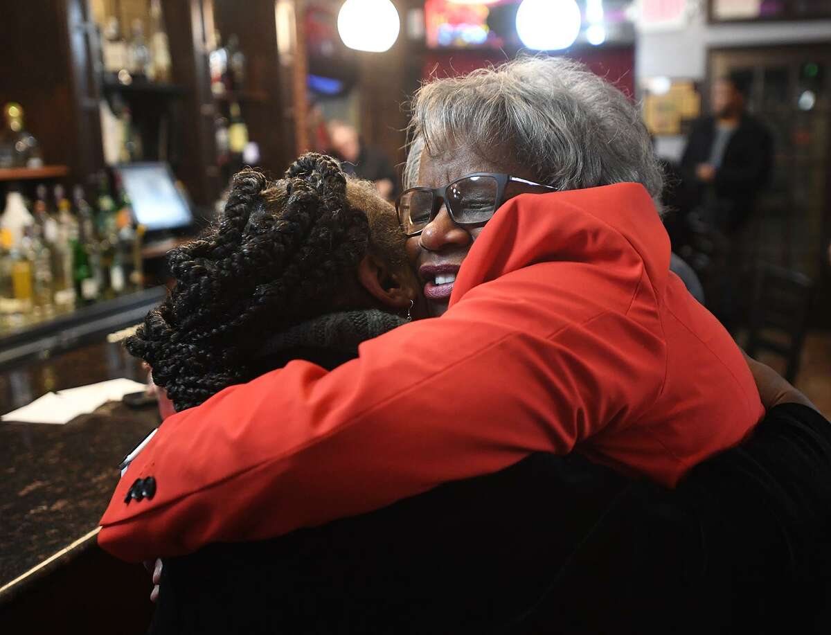 State Sen. Marilyn Moore, right, shares a long hug with former city health director Dr. Marian Evans at her first fundraiser for her mayoral campaign at Metric Bar and Grill in Bridgeport on Monday.