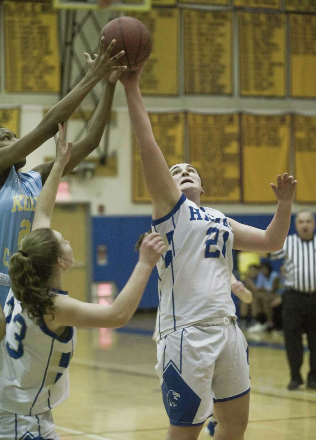 Newtown High School's Nicole DaPra reaches for a rebound during the SWC girls basketball tournament quarterfinal game against Kolbe Cathedral High School, played at Newtown. Monday, Feb. 18, 2019