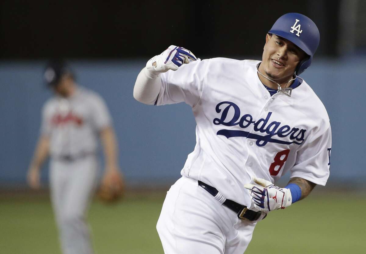 FILE - In this Oct. 5, 2018, file photo, then-Los Angeles Dodgers' Manny Machado celebrates his two-run home run against the Atlanta Braves during the first inning of Game 2 of a baseball National League Division Series, in Los Angeles. A person familiar with the negotiations tells The Associated Press that infielder Manny Machado has agreed to a $300 million, 10-year deal with the rebuilding San Diego Padres, the biggest contract ever for a free agent. The person spoke to the AP on condition of anonymity Tuesday, Feb. 19, 2019, because the agreement was subject to a successful physical and had not been announced. (AP Photo/Jae C. Hong, File)
