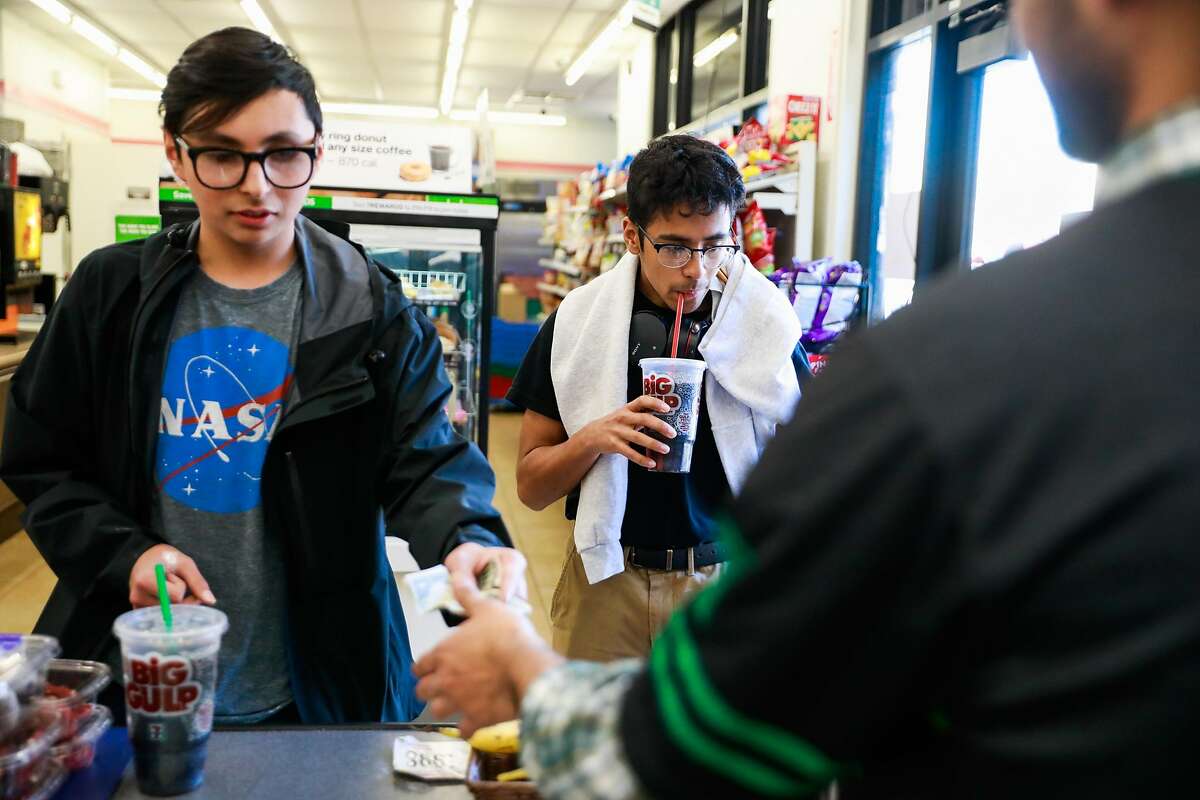 (l-r) Friends Carlos Ramirez, 16 and Josue llamas, 15 buy Big Gulp sodas at 7-11 on Mission Street in San Francisco, California, on Monday, Feb. 18, 2019.