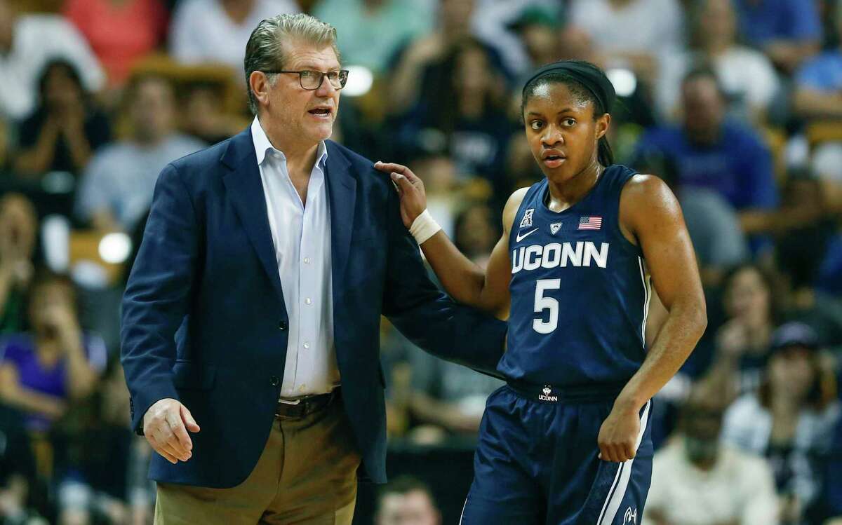 UConn guard Crystal Dangerfield talks to head coach Geno Auriemma during the first quarter of an NCAA college basketball game against Central Florida in Orlando, Fla., on Sunday, Feb. 17, 2019.