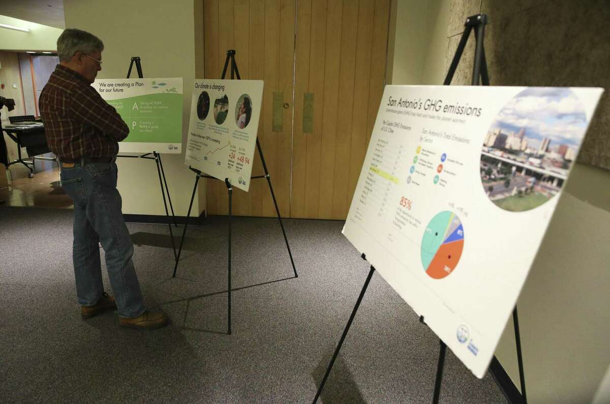 Lee Cunningham studies one of the posters presented at a meeting Feb. 19, 2019, about the city’s draft plan to combat global warming and adapt to it.