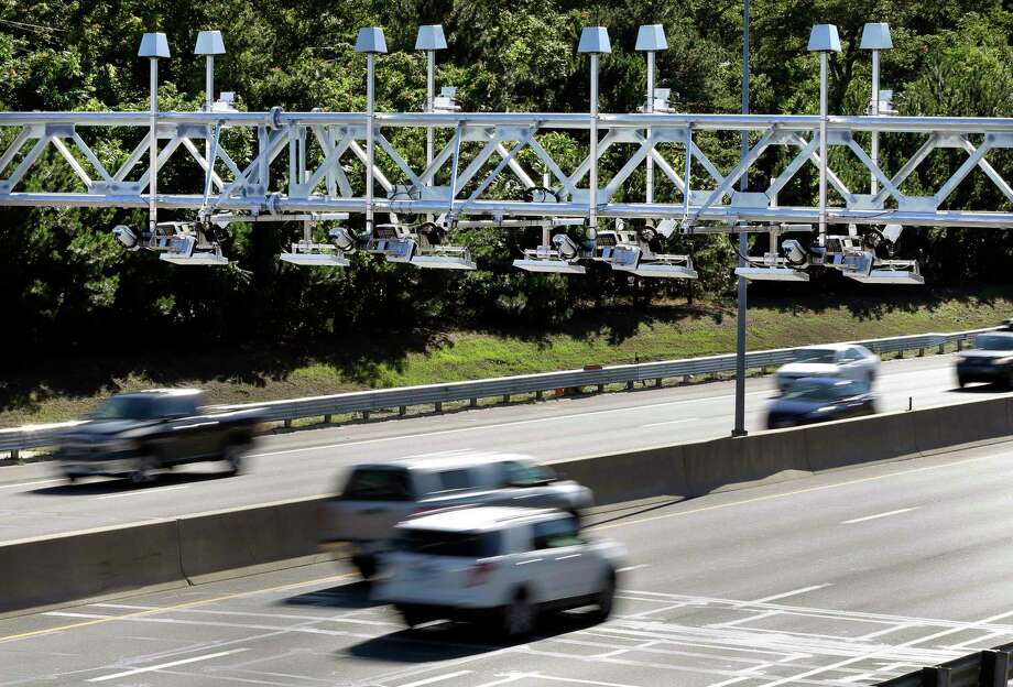 FILE - In this Aug. 22, 2016 file photo, cars pass under toll sensor gantries hanging over the Massachusetts Turnpike in Newton, Mass. Connecticut Gov. Dannel P. Malloy is getting pushback on his plan to spend money on a study of electronic highway tolls in his state. Republican state legislators have balked at the idea, and Democratic State comptroller Kevin Lembo said he will vote against funding the study during a planned vote by the State Bond Commission, scheduled for Wednesday, July 25, 2018. (AP Photo/Elise Amendola, File) Photo: Elise Amendola / Associated Press / AP